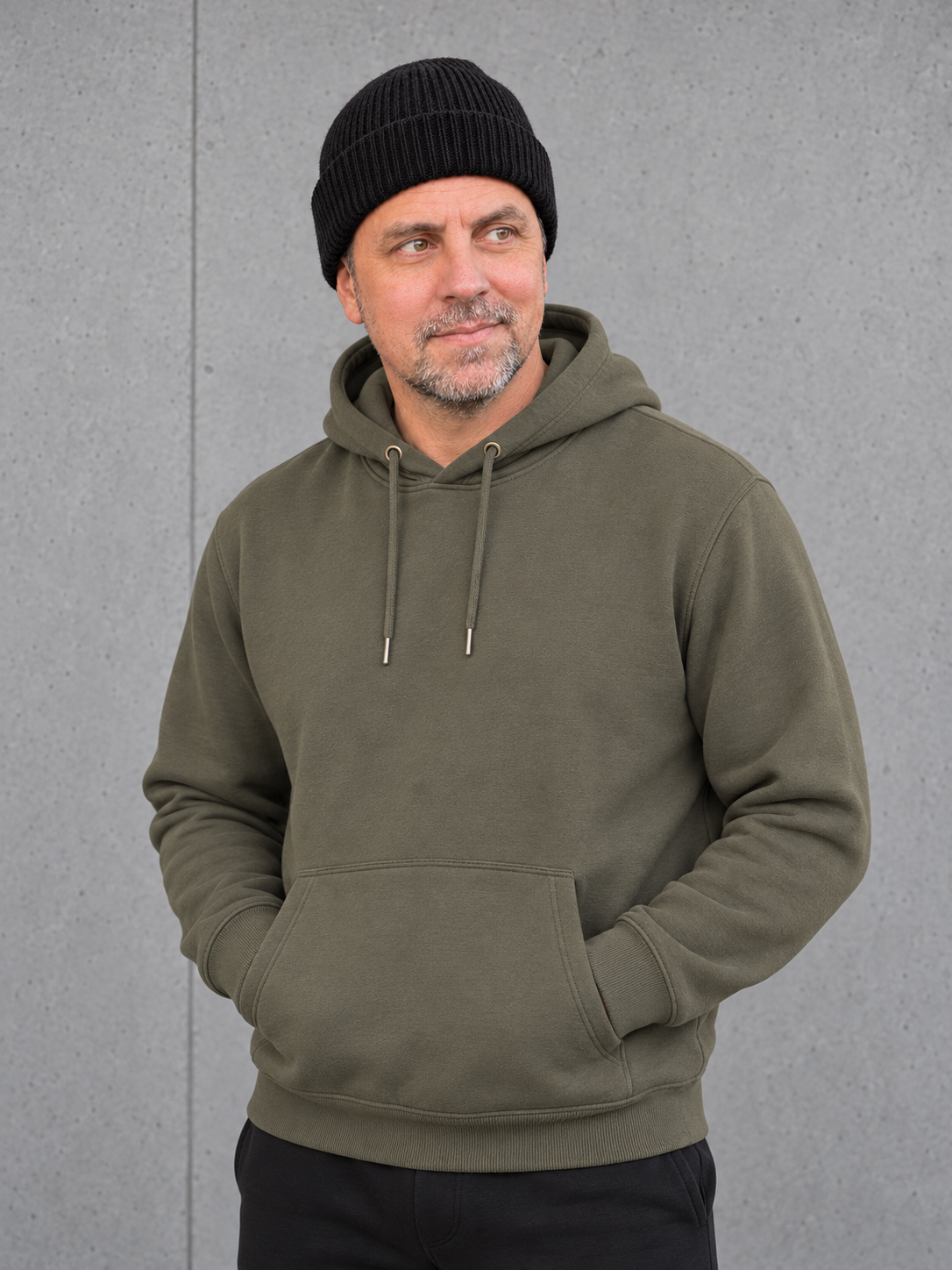 ESSENTIALS Wind Beanie in Black – Frontansicht, getragen von Olli mit Khaki-Hoodie #color_black